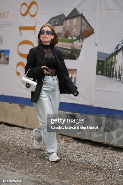 Guest wears navy blue sunglasses, a black tulle with embroidered velvet pattern high neck / long sleeves body, silver earrings, a black blazer...