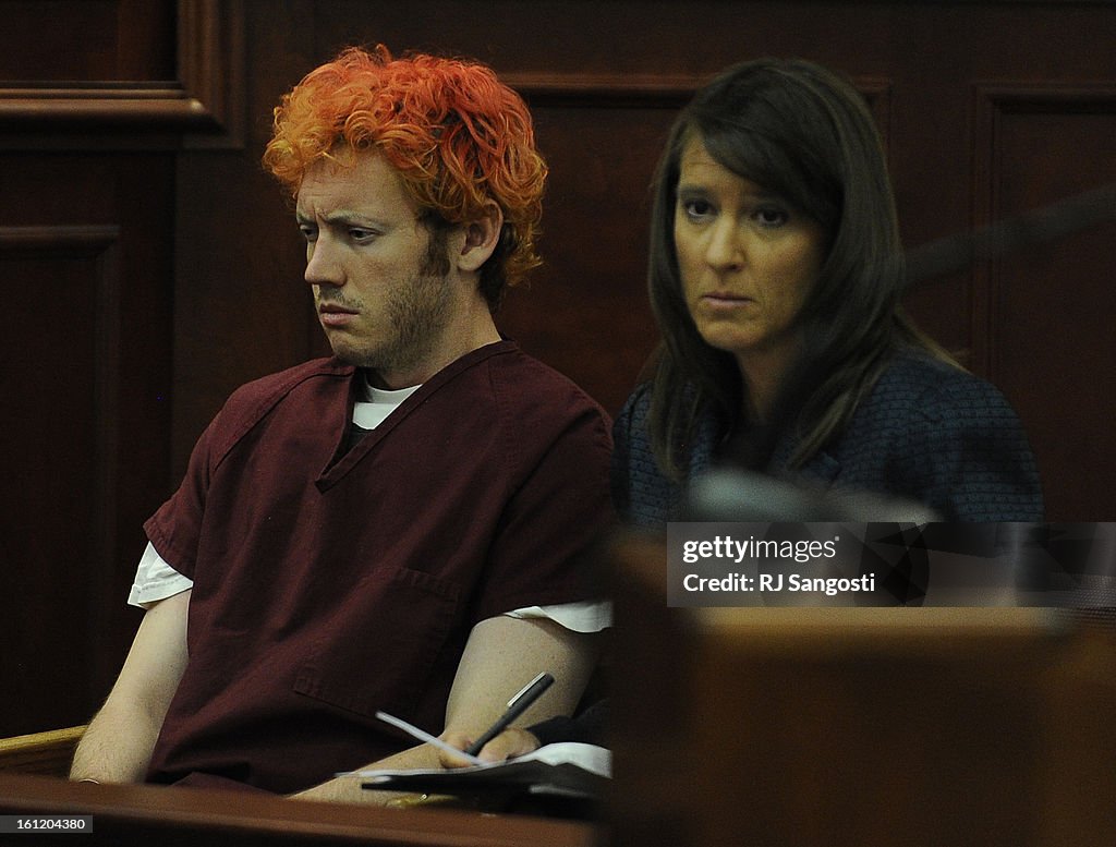 James Holmes, the man accused of killing 12 people and injuring 58 others in the movie theater shooting sits with Tamara Brady a public defender as he appeared before Arapahoe County District Court Judge William B. Sylvester Monday July 23, 2012 for an ad