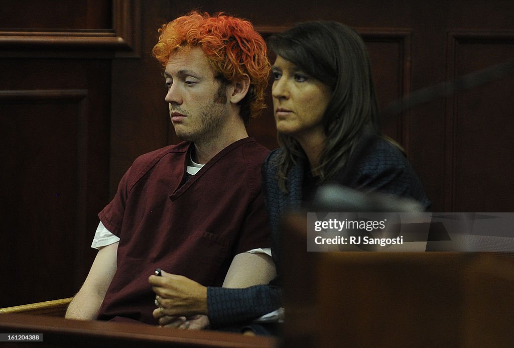 James Holmes, the man accused of killing 12 people and injuring 58 others in the movie theater shooting sits with Tamara Brady a public defender as he appeared before Arapahoe County District Court Judge William B. Sylvester Monday July 23, 2012 for an ad