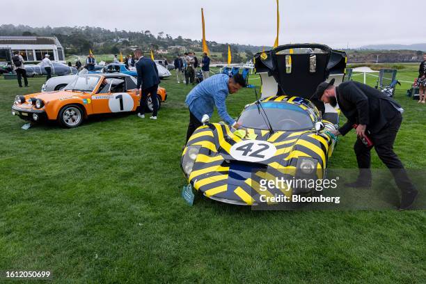 Exhibitors clean a 1967 Porsche 906E Weinberg Coupe during the 2023 Pebble Beach Concours d'Elegance in Pebble Beach, California, US, on Sunday, Aug....