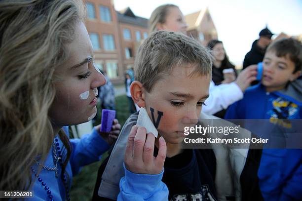 Students entice people to get their Valor spirit on before the 4A Semi-finals football game outside Valor Stadium on Saturday, Nov. 26, 20011....