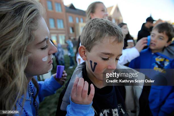 Students entice people to get their Valor spirit on before the 4A Semi-finals football game outside Valor Stadium on Saturday, Nov. 26, 20011....