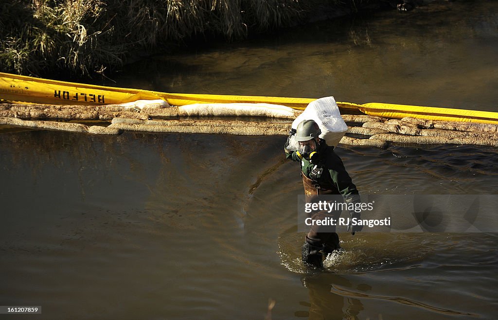 The Enviromental Protection Agency investigate a tip, Tuesday, Nov. 29, 2011, that an oily muck is running into Sand Creek near Suncor Energy in Commerce City. Crews work on cleaning an oily muck that is running into Sand Creek near Suncor Energy in Comme