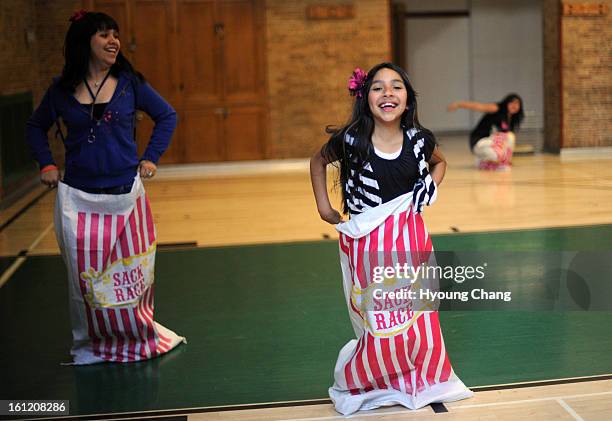 From left, Esmeralda Amaya Stephany Zambrano and Brenda Padilla are in the sack race of Skinner Community Night at Skinner Middle School on Thursday....