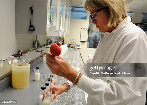 Physical Scientist Dee Jae Dutton performs tests on samples of pasteurized milk submitted every month from dairies across the state. The Colorado...