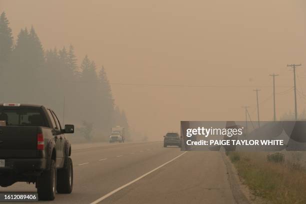 Traffic on Hwy 1 drives through heavy wildfire smoke from the nearby Bush Creek East Wildfire in Sorrento, British Columbia, on August 20, 2023. Two...