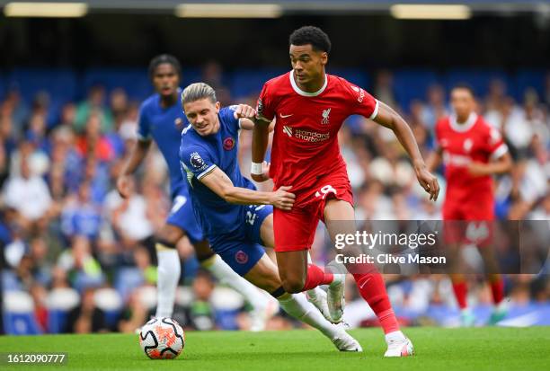 Conor Gallagher of Chelsea and Cody Gakpo of Liverpool battle for possession during the Premier League match between Chelsea FC and Liverpool FC at...