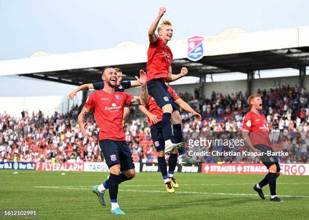SpVgg Unterhaching players celebrate the team's victory following the DFB cup first round match between SpVgg Unterhaching and FC Augsburg at...