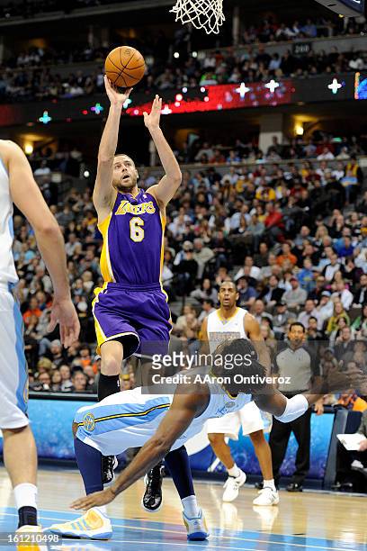 Los Angeles Lakers power forward Josh McRoberts charges Denver Nuggets center Nene during the second quarter at the Pepsi Center on Sunday, January...