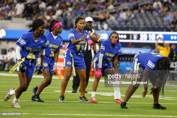 Inglewood, CA The quarterback for Crenshaw girls flag football catches the snap as they play King/Drew at halftime of the Rams and Raiders preseason...