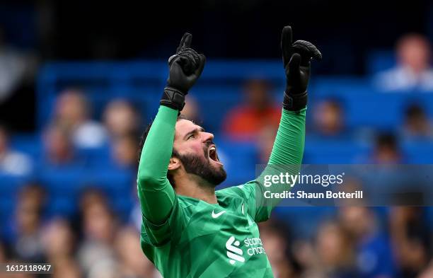 Alisson Becker of Liverpool celebrates after teammate Luis Diaz scores the team's first goal during the Premier League match between Chelsea FC and...