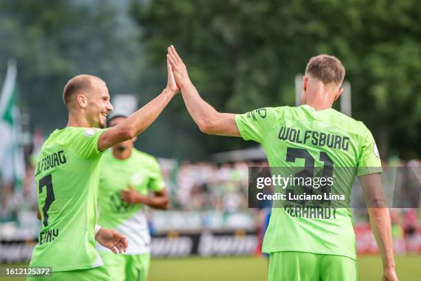 Yannick Gerhardt of VfL Wolfsburg celebrates with teammate after scoring his team's fourth goal during the DFB cup first round match between TuS...