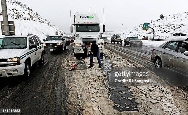 Rrok Prelaj, a truck driver for FedEx, keeps himself busy as he waits on I-70 near exit 259, Thursday Feb. 23 in Morrison. West bound I-70 was closed...