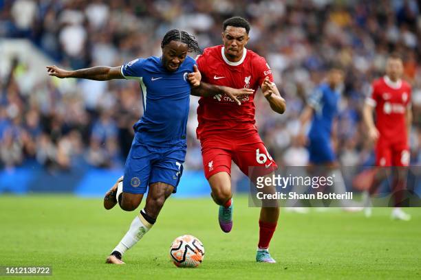 Raheem Sterling of Chelsea runs with the ball whilst under pressure from Trent Alexander-Arnold of Liverpool during the Premier League match between...