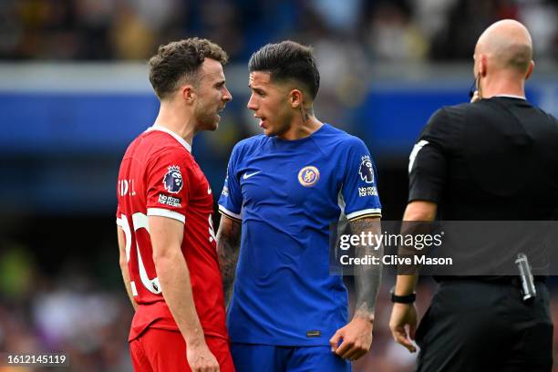 Diogo Jota of Liverpool clashes with Enzo Fernandez of Chelsea in front of Referee Anthony Taylor, before both are awarded yellow cards, during the...