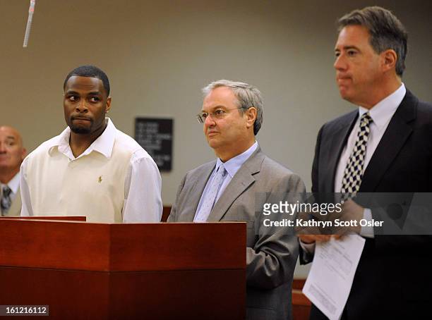Denver Broncos cornerback Perrish Cox, left, standing with his attorney Harvey Steinberg, watches as Craig Silverman, right, the attorney...