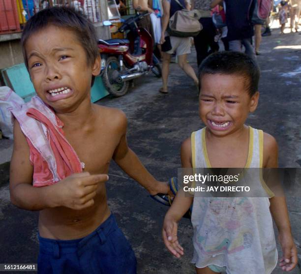 Allan Quadro , cry in panic with his brother in the eastern Philippine village of Rawis, Legazpi after a rumour spread that a tsunami was about to...