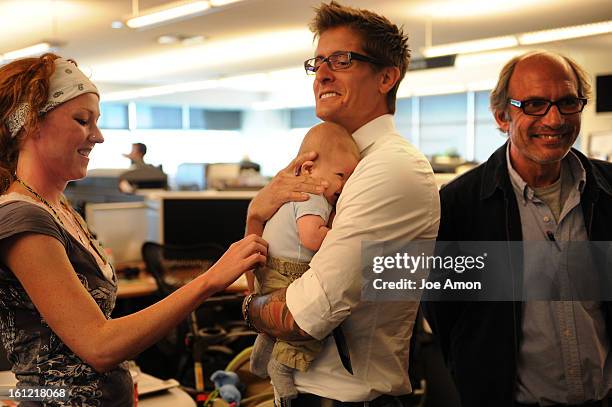 Jamie Cotten Walker fondles her baby as former United States Marine Scott Ostrom holds Quinn Walker, the son of Craig F. Walker of the Denver Post...