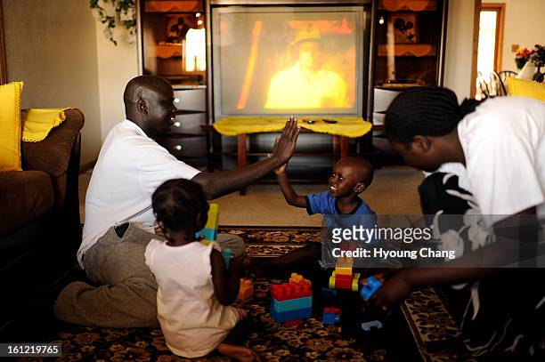 Sudan lost boy Gatbel Chamjock left, spends time with his family at their house in Sterling, Colo., on Wednesday, April 18, 2012. Gatbel has found...