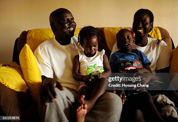 Sudan lost boy Gatbel Chamjock left, spends time with his family at their house in Sterling, Colo., on Wednesday, April 18, 2012. Gatbel has found...