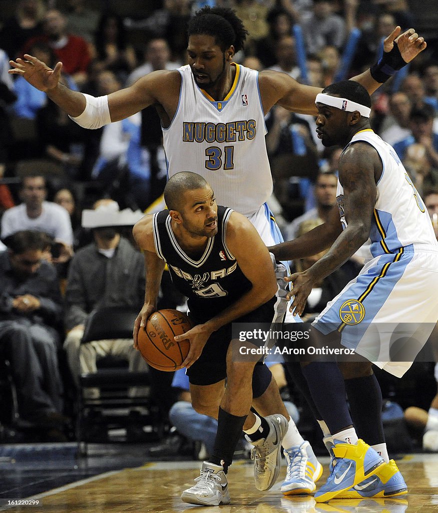 San Antonio Spurs point guard Tony Parker (9) looks for an open teammate as he is defended by Denver Nuggets center Nene (31) and Ty Lawson (3) during the second half on Wednesday, March 23, 2011 at the Pepsi Center. AAron Ontiveroz, The Denver Post