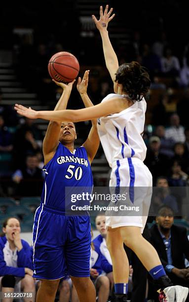 Grandview Sedia Olsen, left, makes three points shot against Highlands Ranch Abriana Lujan during quarter final of 5A girls state championship game...