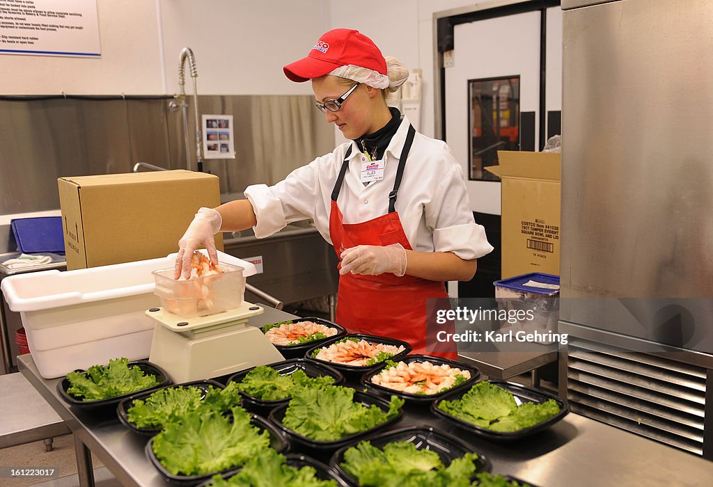 Costco employee Aliaksandra Lobkis weighed shrimp for shrimp cocktails she was putting together at the store at 4000 River Point Parkway in Sheridan Friday afternoon, October 28, 2011. Karl Gehring/The Denver Post