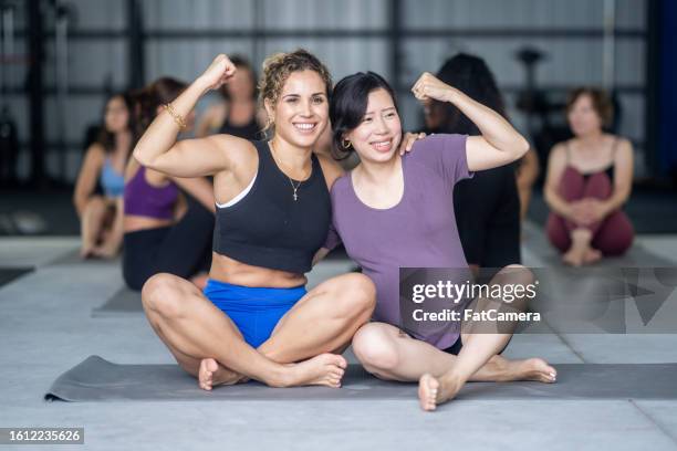 feeling strong - group of people flexing biceps stock pictures, royalty-free photos & images