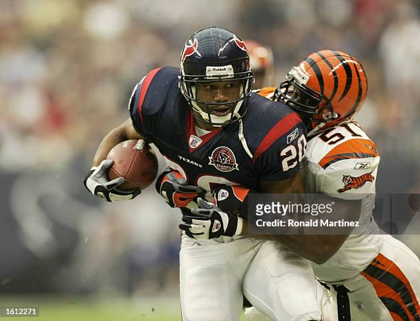 Linebacker Takeo Spikes of the Cincinnati Bengals tackles running back James Allen of the Houston Texans on November 3, 2002 at Reliant Stadium in...