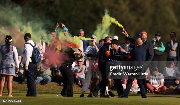 Protestors make their way onto the 17th green on Day Four of the AIG Women's Open at Walton Heath Golf Club on August 13, 2023 in Tadworth, England.