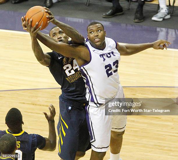 West Virginia's Aaric Murray takes a rebound away from Texas Christian's Devonta Abron at Daniel-Meyer Coliseum in Fort Worth, Texas, on Saturday,...