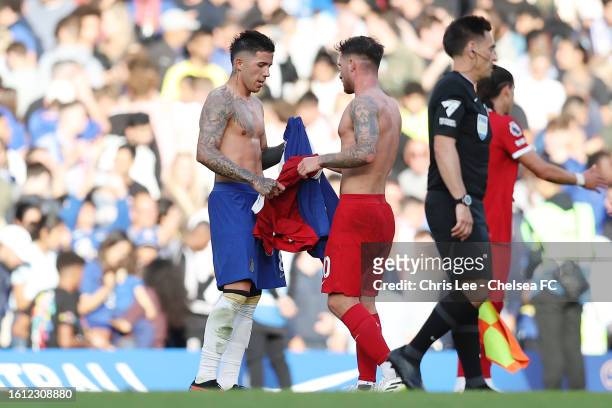 Enzo Fernandez of Chelsea and Alexis Mac Allister of Liverpool swap shirts after the draw in the Premier League match between Chelsea FC and...