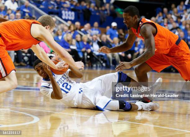 Kentucky's Ryan Harrow looks for help as Auburn's Rob Chubb, left, and Shaquille Johnson close in at Rupp Arena on Saturday, February 9 in Lexington,...
