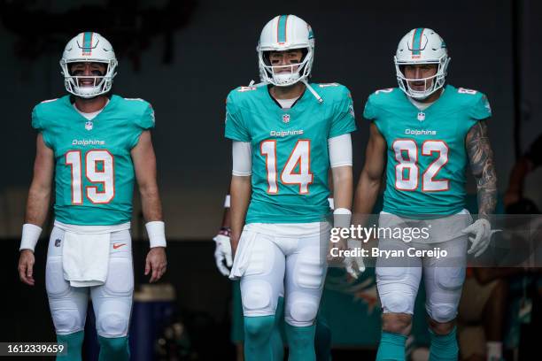 Quarterback Skylar Thompson of the Miami Dolphins , quarterback Mike White of the Miami Dolphins , and tight end Eric Saubert of the Miami Dolphins...