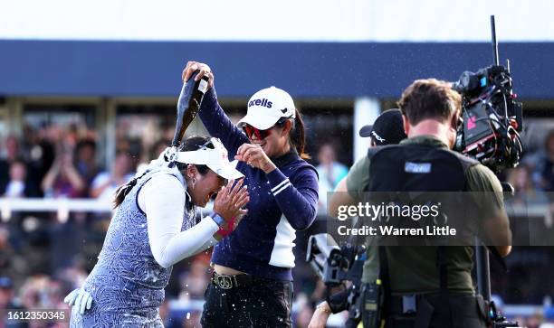 Lilia Vu of the United States celebrates on the 18th green as they are sprayed with champagne after winning the AIG Women's Open on Day Four of the...