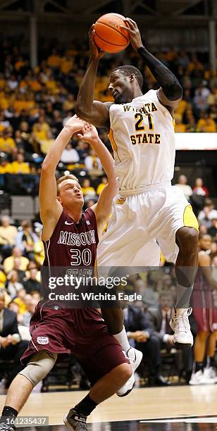 Wichita State's Ehimen Orukpe pulls down an inbound pass against Missouri State's Nathan Scheer in the first half at Koch Arena in Wichita, Kansas,...