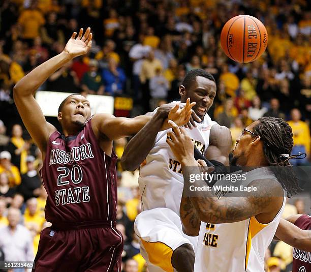 Wichita State's Ehimen Orukpe, middle, and Carl Hall, right, fight for a rebound with Missouri State's Gavin Thurman in the first half at Koch Arena...