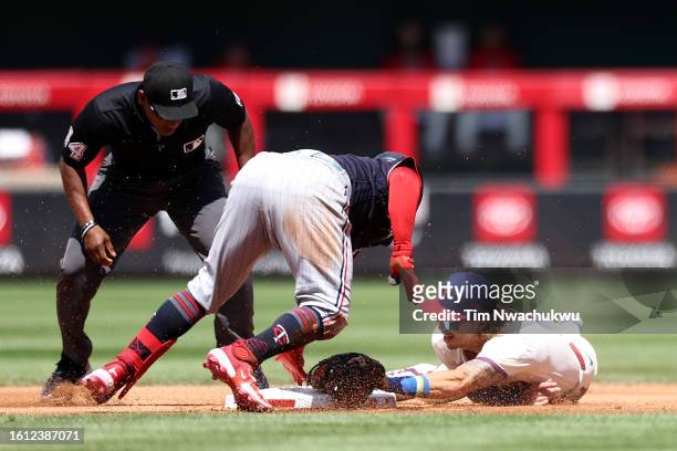 Christian Vazquez of the Minnesota Twins is tagged by Bryson Stott of the Philadelphia Phillies during the second inning at Citizens Bank Park on...