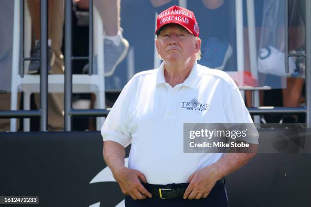 Former President Donald Trump looks on at the first tee prior to the start of day three of the LIV Golf Invitational - Bedminster at Trump National...