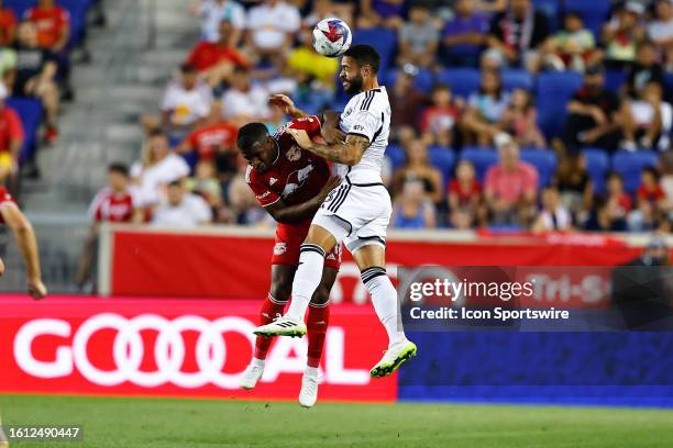 Derrick Williams of D.C. United heads the ball against Elias Manoel of New York Red Bulls during the Major League Soccer game on August 20, 2023 at...