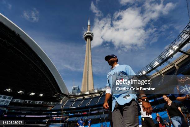 Former Toronto Blue Jay José Bautista walks out of the dugout after signing a one-day contract with the Toronto Blue Jays, ahead of his retirement,...