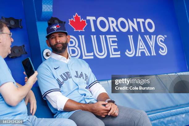 Former Toronto Blue Jay José Bautista talks with media in the dugout after signing a one-day contract with the Toronto Blue Jays, ahead of his...