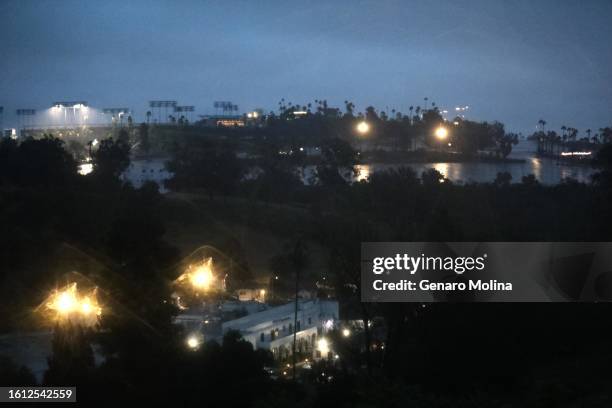 Dodgers Stadium continues to glow above Elysian Park during Hurricane Hilary, now a tropical storm, in Los Angeles on August 20, 2023.