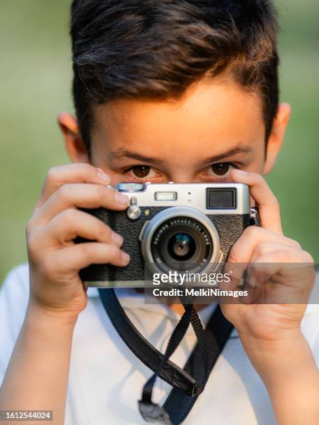 young boy having fun taking a photos of the nature - young photographer stock pictures, royalty-free photos & images