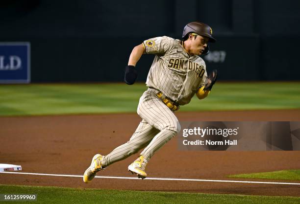 Ha-Seong Kim of the San Diego Padres rounds third base and scores on a single hit by Fernando Tatis Jr against the Arizona Diamondbacks during the...
