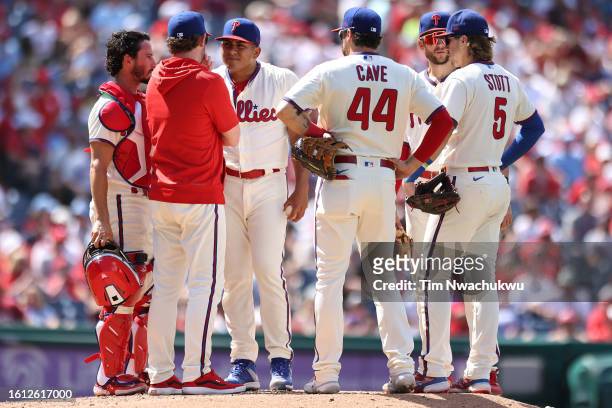 The Philadelphia Phillies huddle during the sixth inning against the Minnesota Twins at Citizens Bank Park on August 13, 2023 in Philadelphia,...