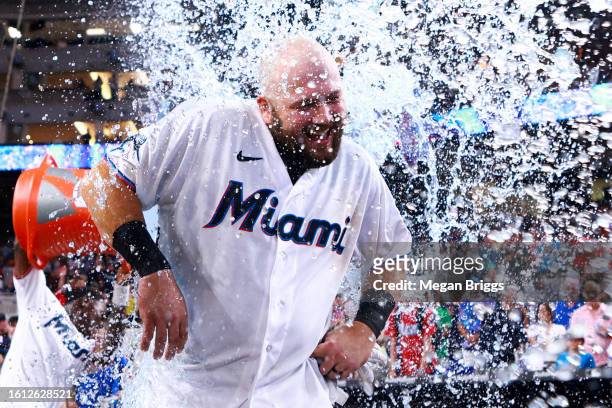 Jake Burger of the Miami Marlins receives a gatorade bath after hitting a walk-off RBI single to defeat the New York Yankees at loanDepot park on...