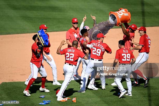 Jeter Downs of the Washington Nationals celebrates with teammates after driving in the game winning run in the ninth inning against the Oakland...