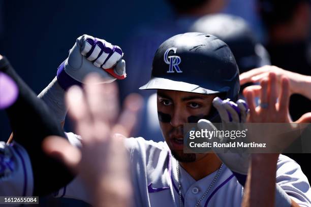 Alan Trejo of the Colorado Rockies celebrates a two-run home run against the Los Angeles Dodgers in the fourth inning at Dodger Stadium on August 13,...