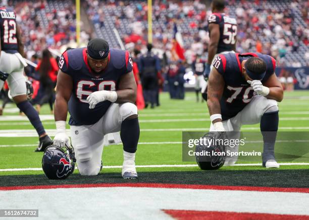 Houston Texans guard Shaq Mason and Houston Texans center Juice Scruggs take a moment after entering the field during the preseason NFL game between...